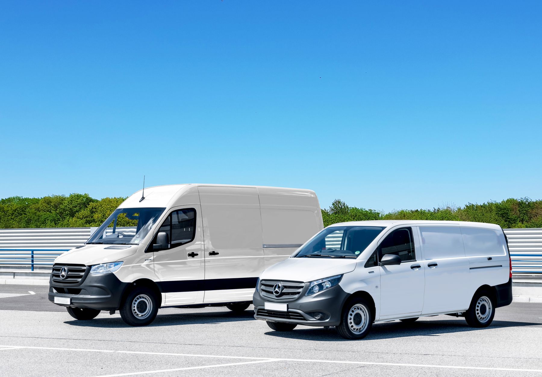 White Mercedes-Benz Sprinter van beside a smaller Mercedes-Benz van