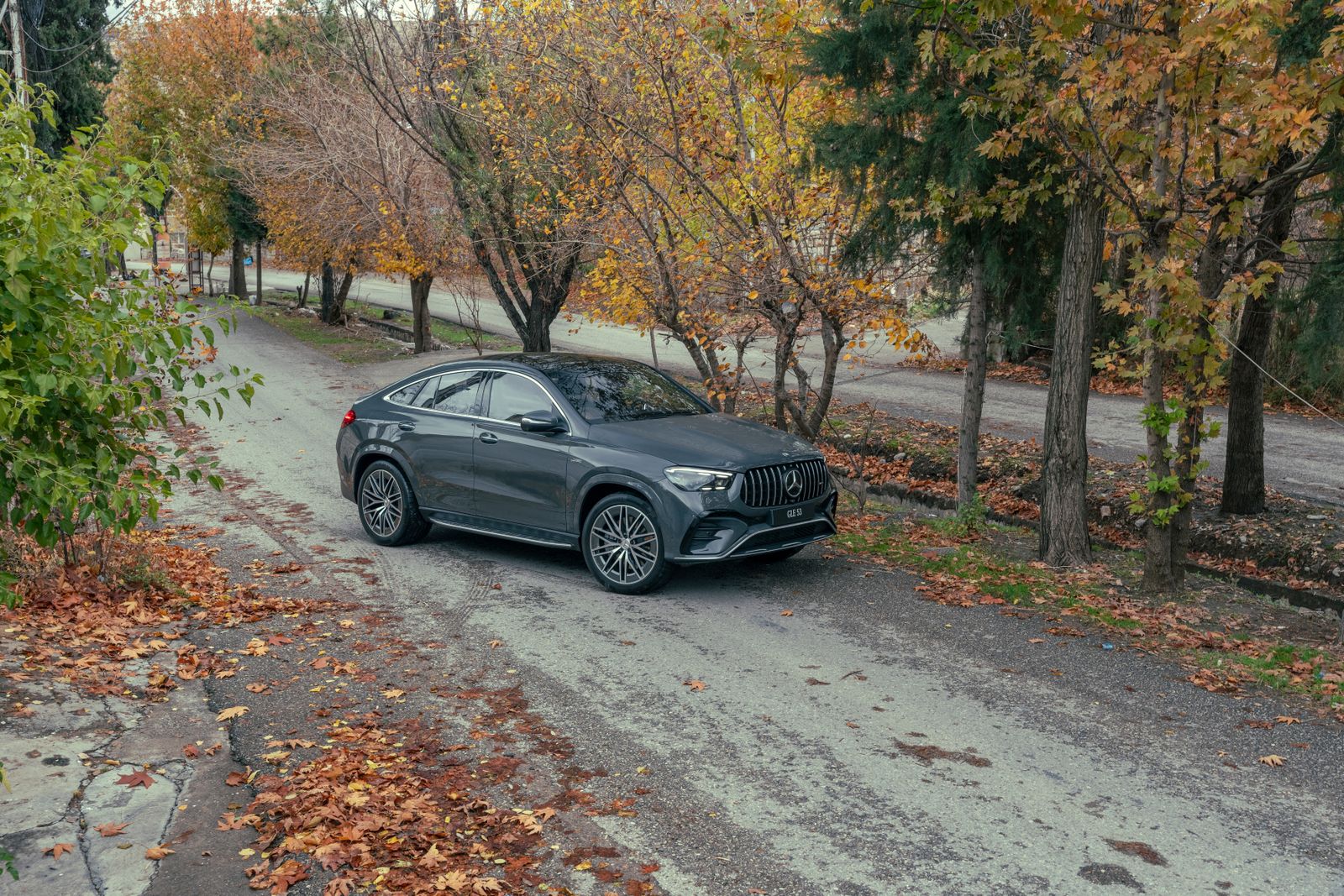 Gray Mercedes-AMG GLE 53 Coupe on an autumn road