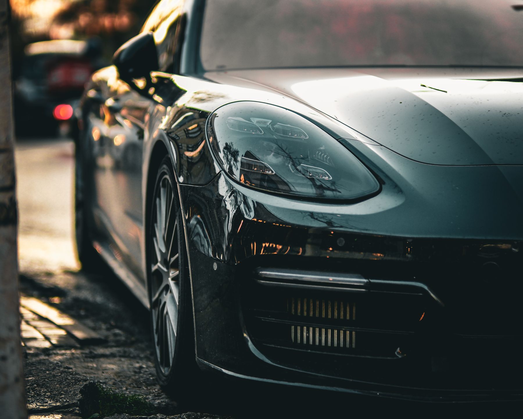 A black sedan, front detail at sunset